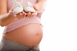 Surrogacy matters: surrogate holding baby shoes